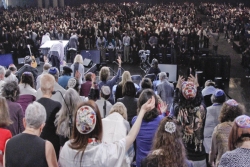 Convention hall full of people during Biennial Shabbat worship service